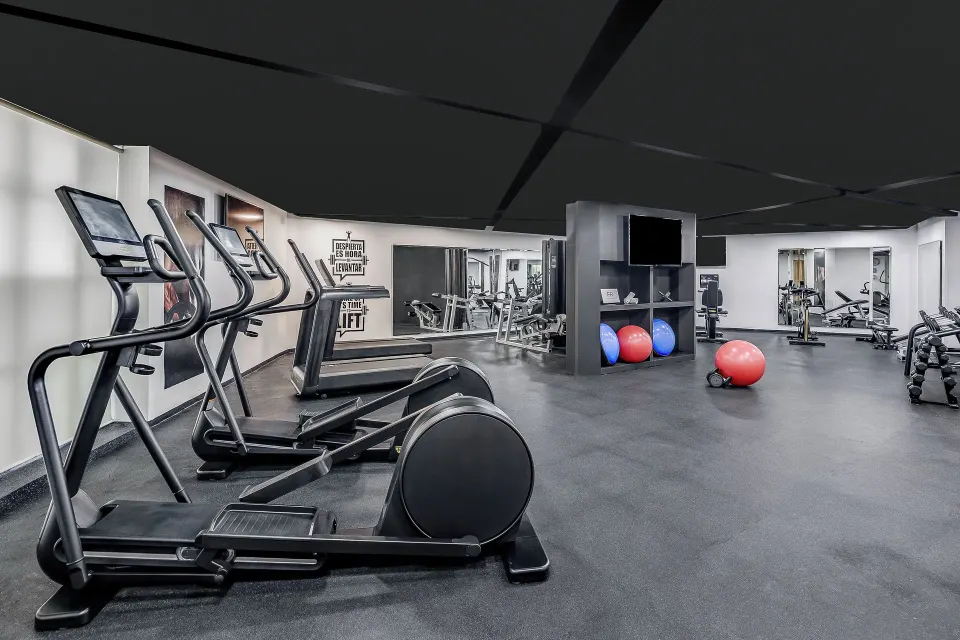 Fitness center with ellipticals, exercise balls and weights at Fiesta Americana Cancun Villas.