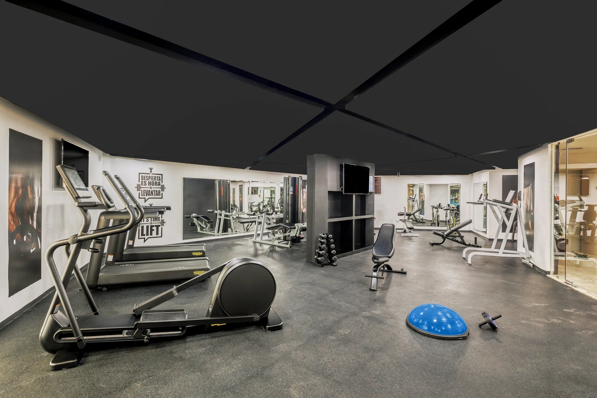 Fitness room with cardio and weight equipment at Fiesta Americana Cancun Villas.