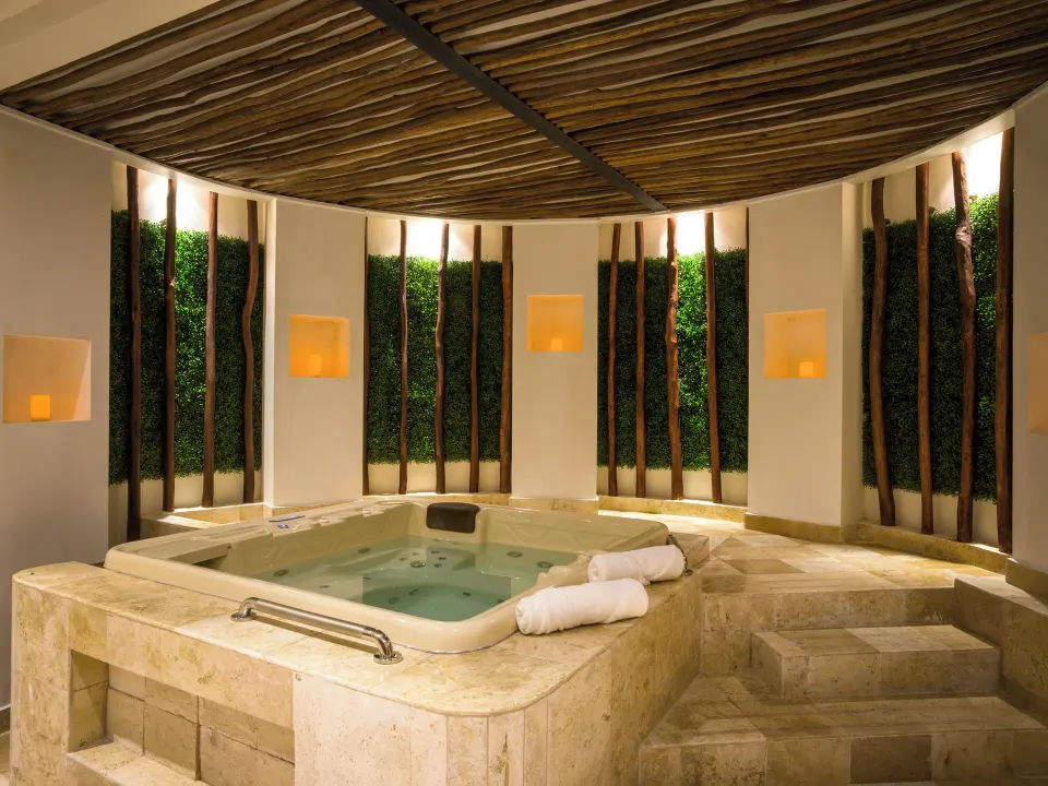 Indoor spa whirlpool with towels and wood accents at Fiesta Americana Cancun Villas.