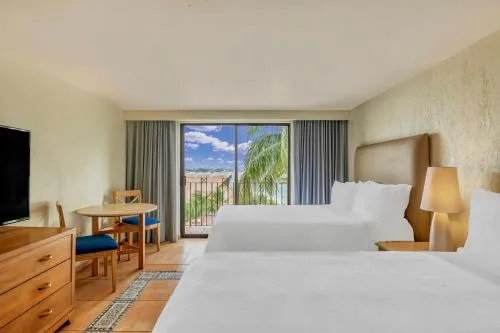 Bright 2 Bedroom Master Suite bedroom with two beds and balcony at Fiesta Americana Cancun Villas.
