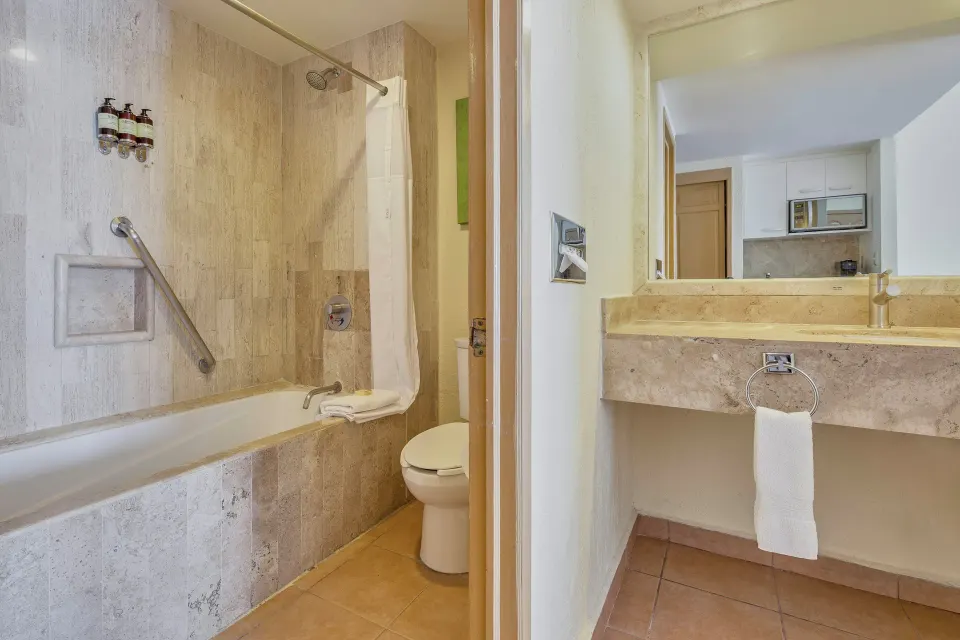 Deluxe Villa bathroom tub, toilet, and vanity at Fiesta Americana Cancun Villas.