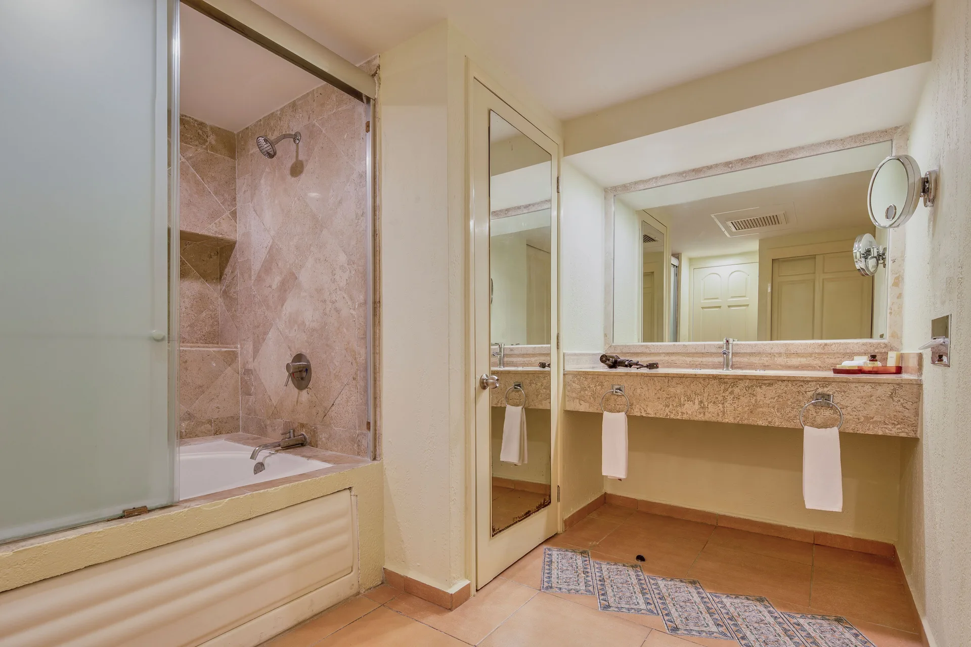 Deluxe Villa bathroom with tub-shower and long vanity at Fiesta Americana Cancun Villas.