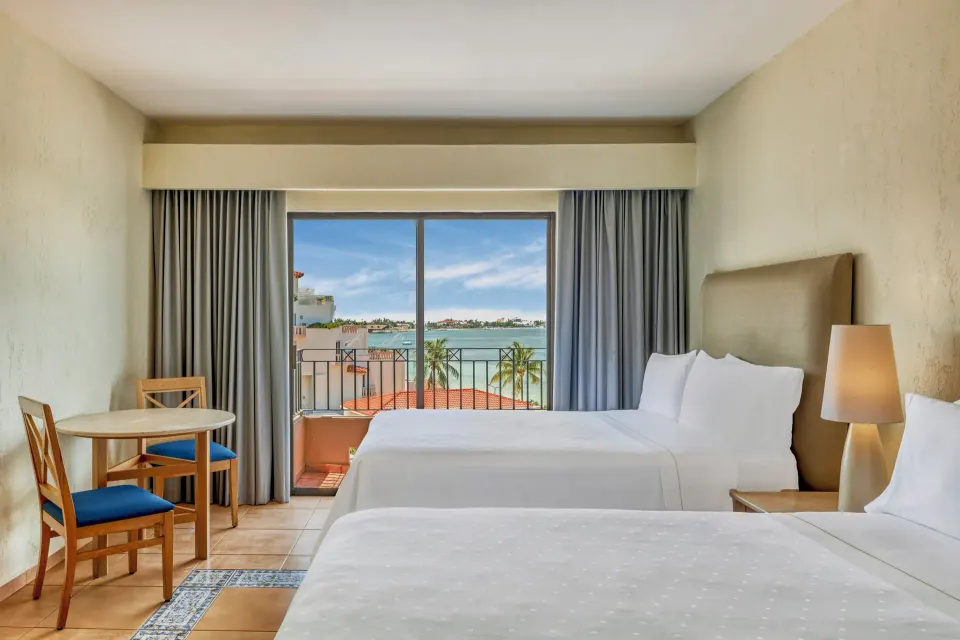 Deluxe Villa with two beds and balcony water view at Fiesta Americana Cancun Villas.