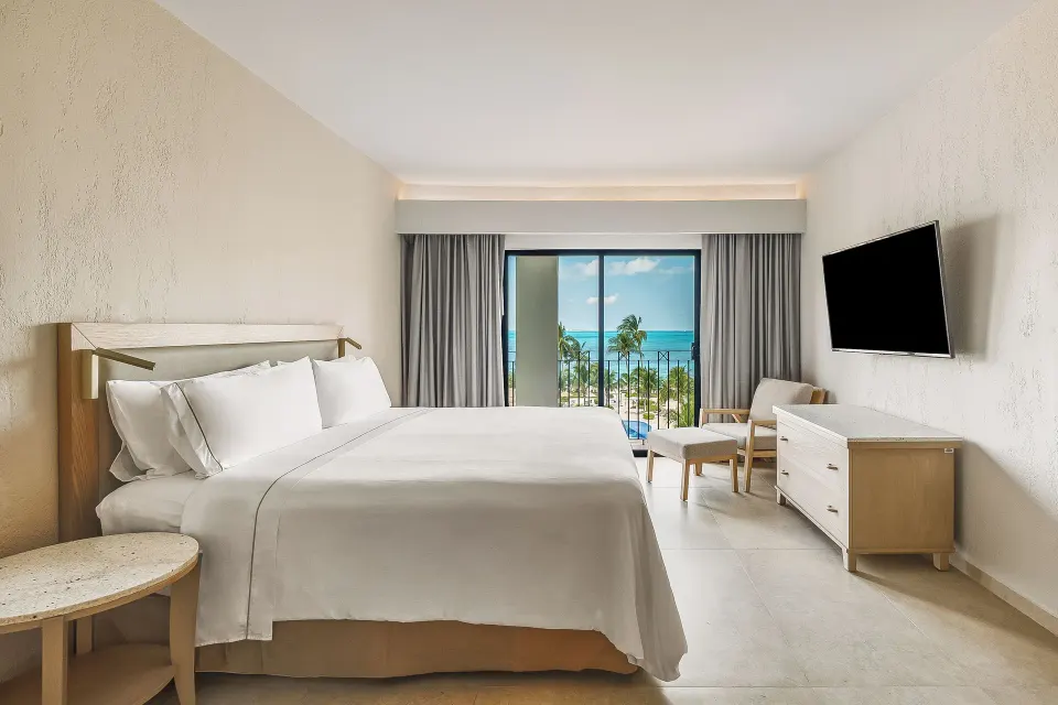 Premium Villa Master Suite bedroom with king bed and balcony at Fiesta Americana Cancun Villas.