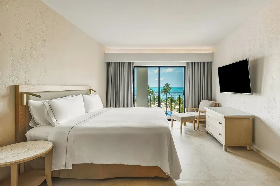 Premium Villa Master Suite king bedroom with ocean-facing balcony at Fiesta Americana Cancun Villas.