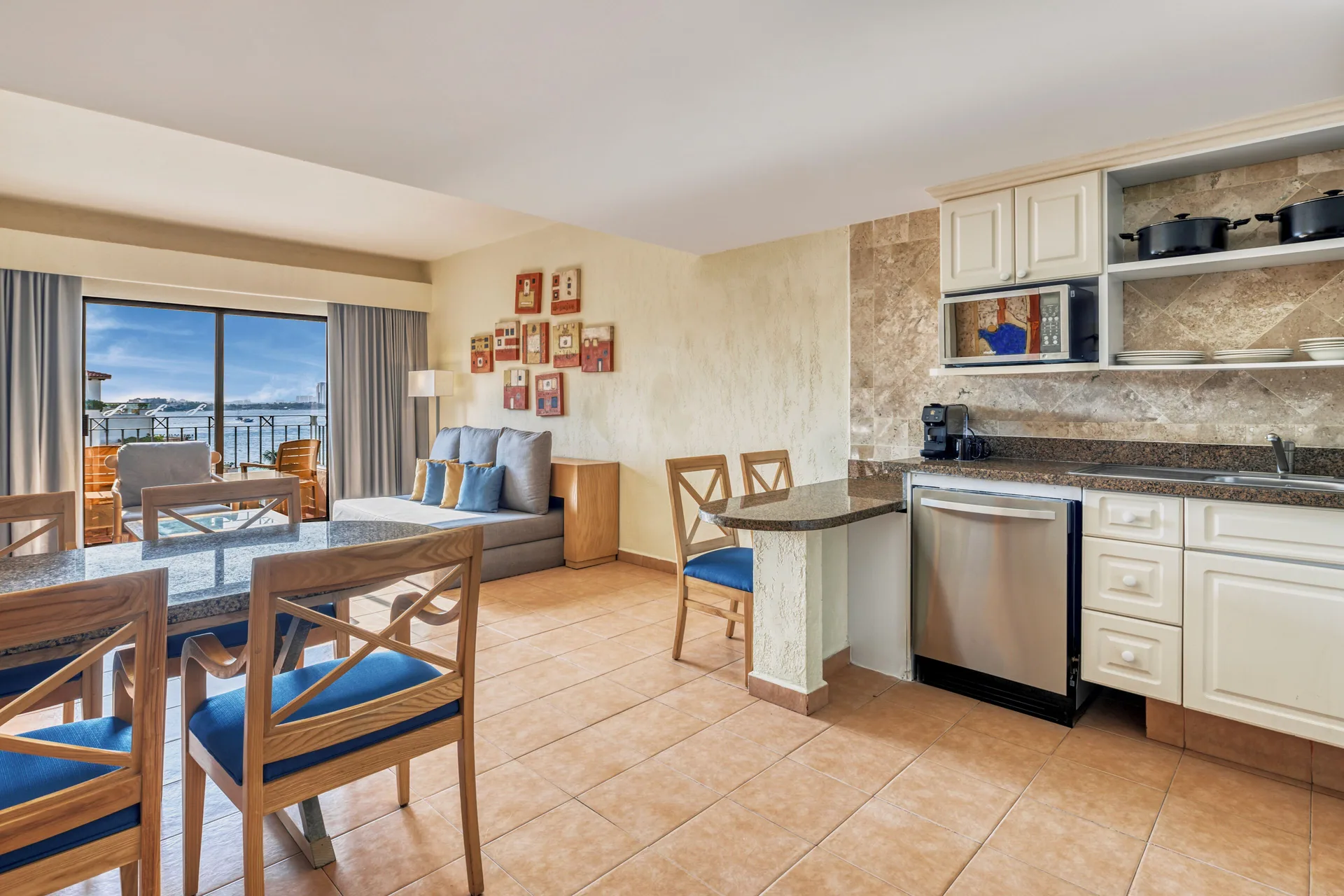 Villa Master Suite dining area and kitchenette with ocean-facing balcony at Fiesta Americana Cancun Villas.