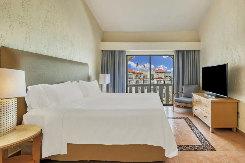 Villa Master Suite bedroom with king bed and balcony at Fiesta Americana Cancun Villas.