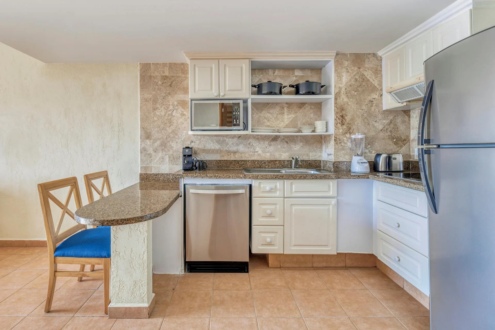 Villa Master Suite kitchenette with bar seating at Fiesta Americana Cancun Villas.