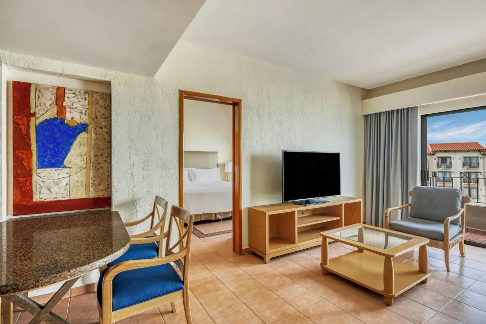 Villa Master Suite living area with dining table and balcony at Fiesta Americana Cancun Villas.