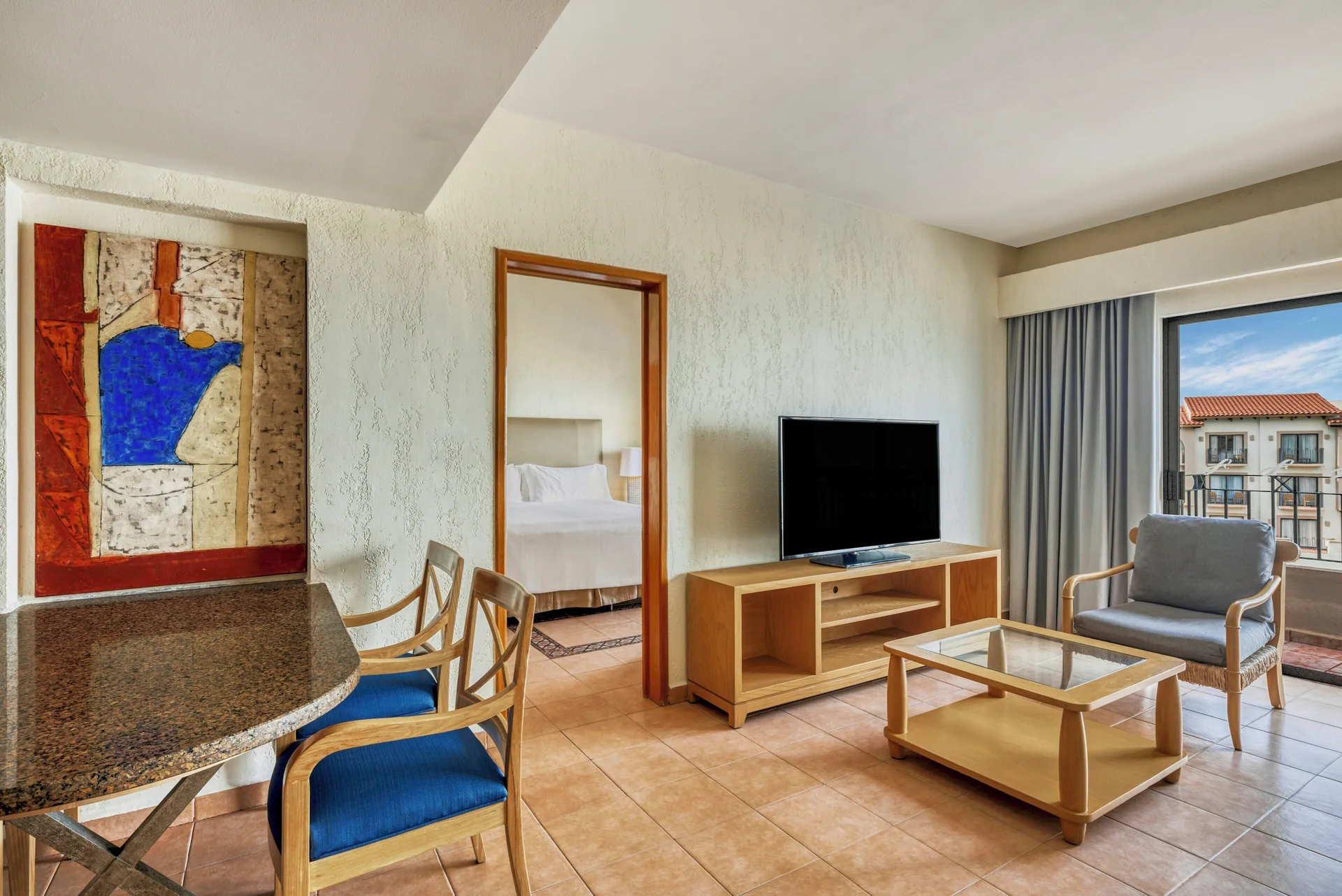 Villa Master Suite living area with dining table and balcony at Fiesta Americana Cancun Villas.