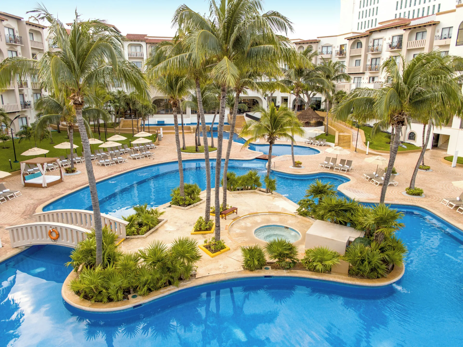Villa Master Suite pool-area view at Fiesta Americana Cancun Villas with palms and loungers.