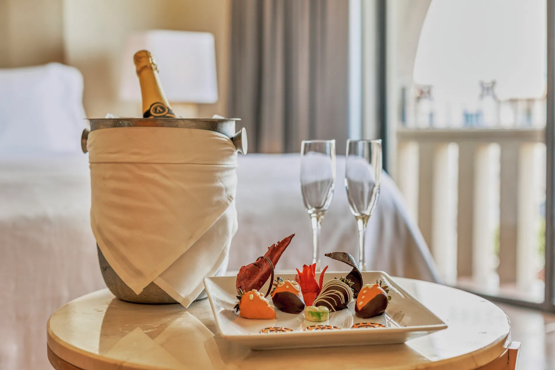 Villa Master Suite table with chilled bottle and sweets at Fiesta Americana Cancun Villas.