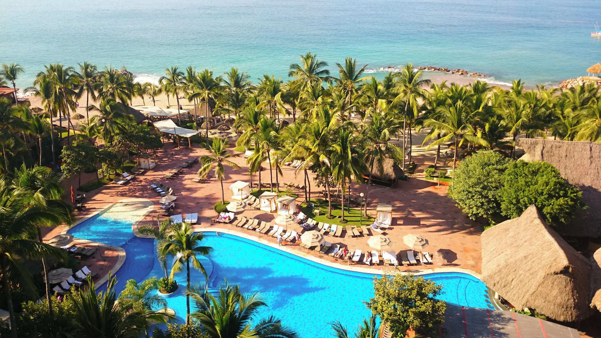 Aerial view of pool, palms, beach, and ocean at Fiesta Americana Puerto Vallarta & Spa.