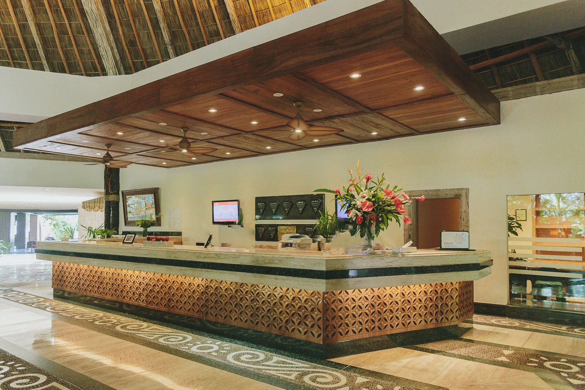 Front desk with floral arrangement at Fiesta Americana Puerto Vallarta & Spa.