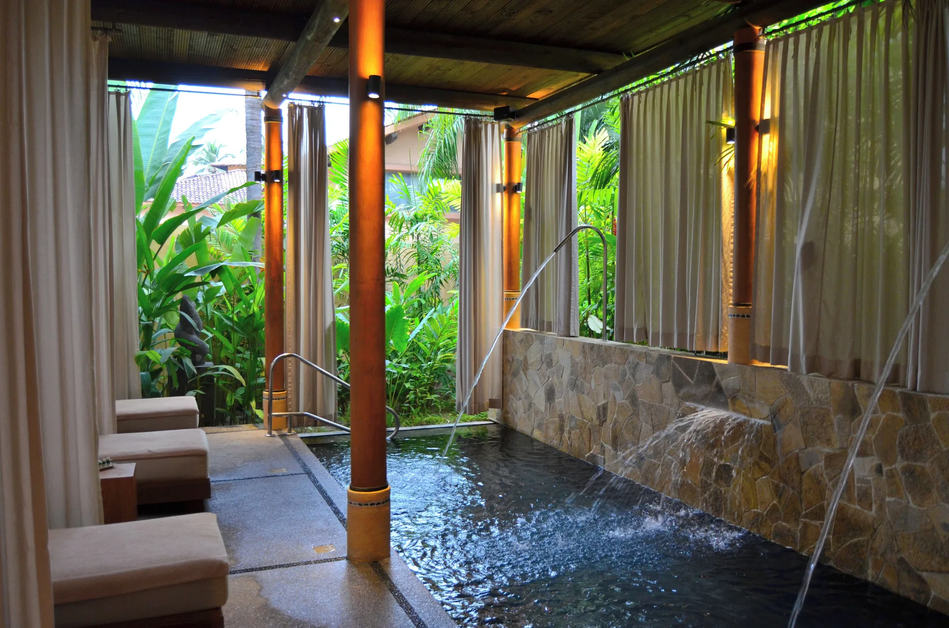 Spa hydrotherapy pool with curtains and tropical plants at Fiesta Americana Puerto Vallarta & Spa.