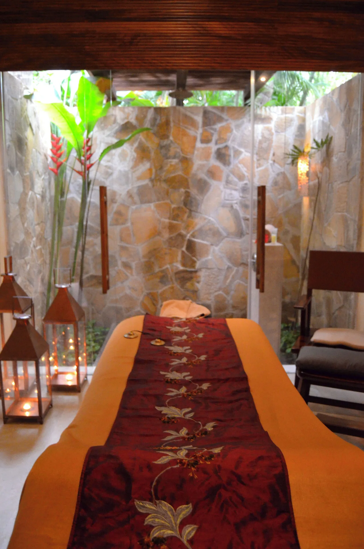 Spa massage table with candles and stone walls at Fiesta Americana Puerto Vallarta & Spa.