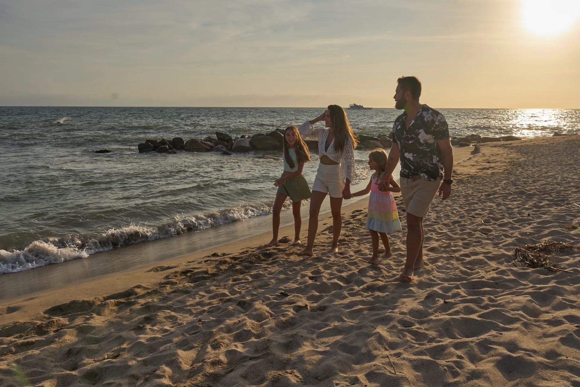 Family walking on the beach at sunset near Fiesta Americana Puerto Vallarta & Spa.