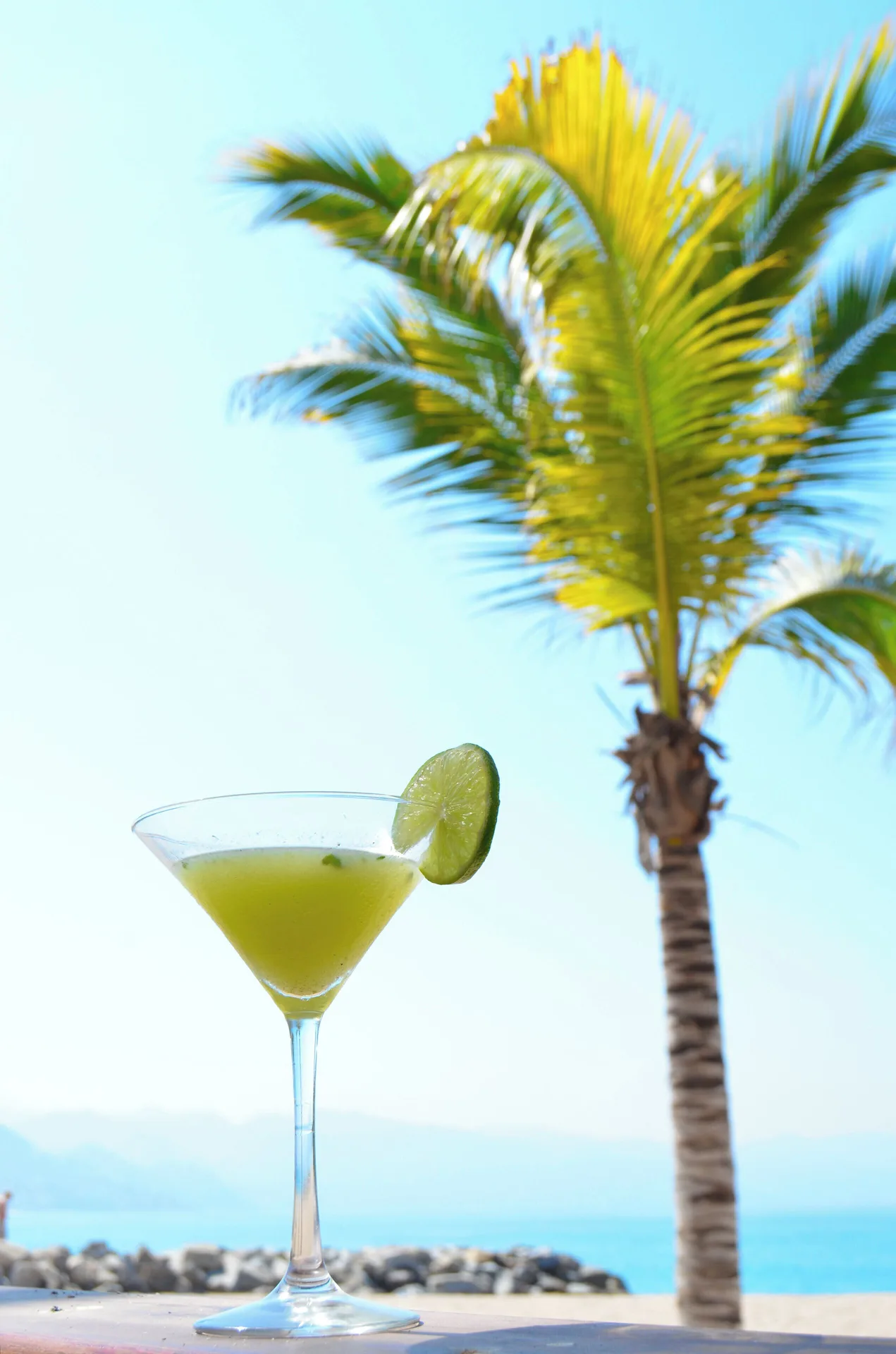 Green cocktail with lime by the ocean at Fiesta Americana Puerto Vallarta & Spa.
