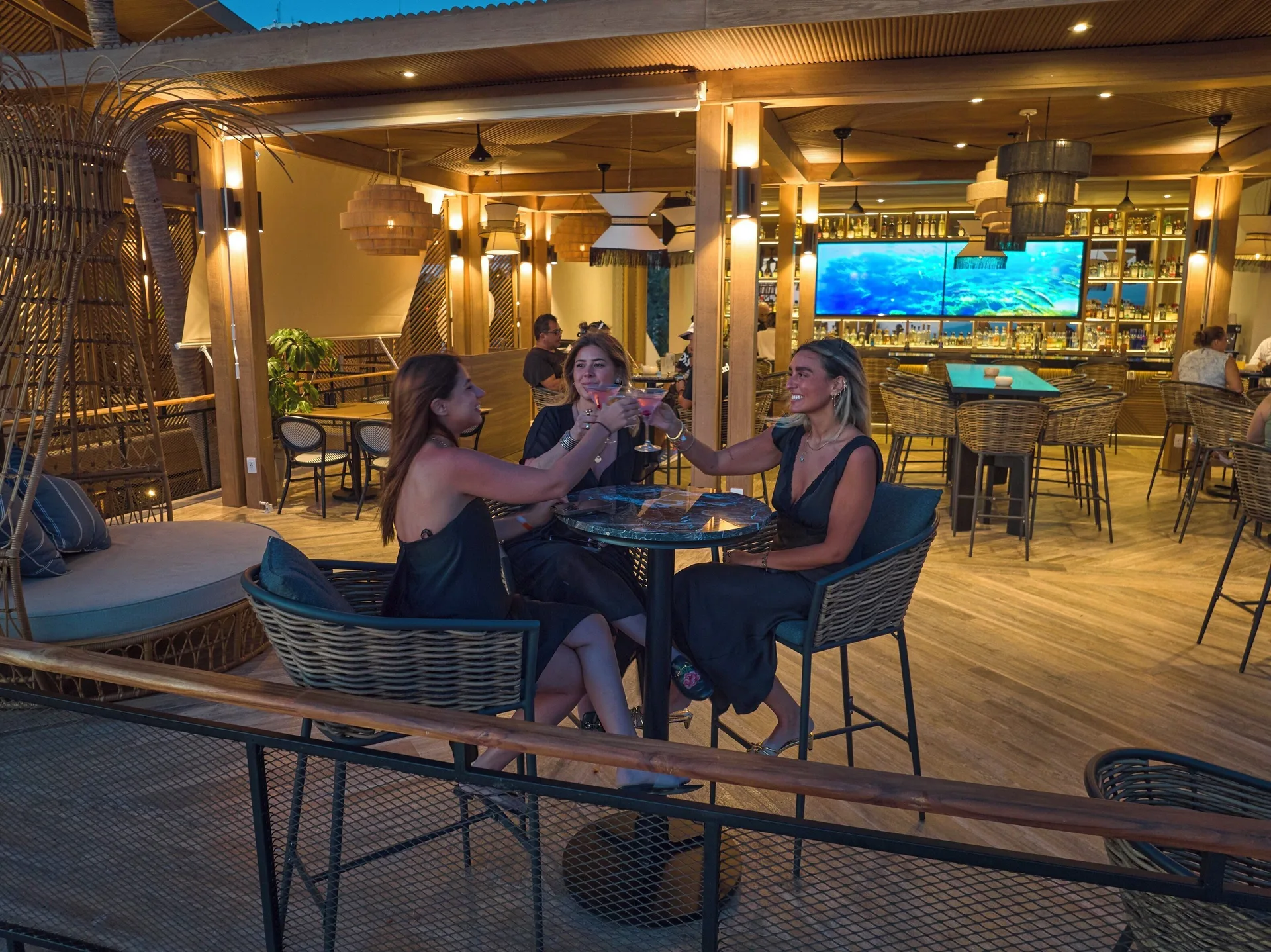 Guests toasting cocktails in a lounge bar at Fiesta Americana Puerto Vallarta & Spa.