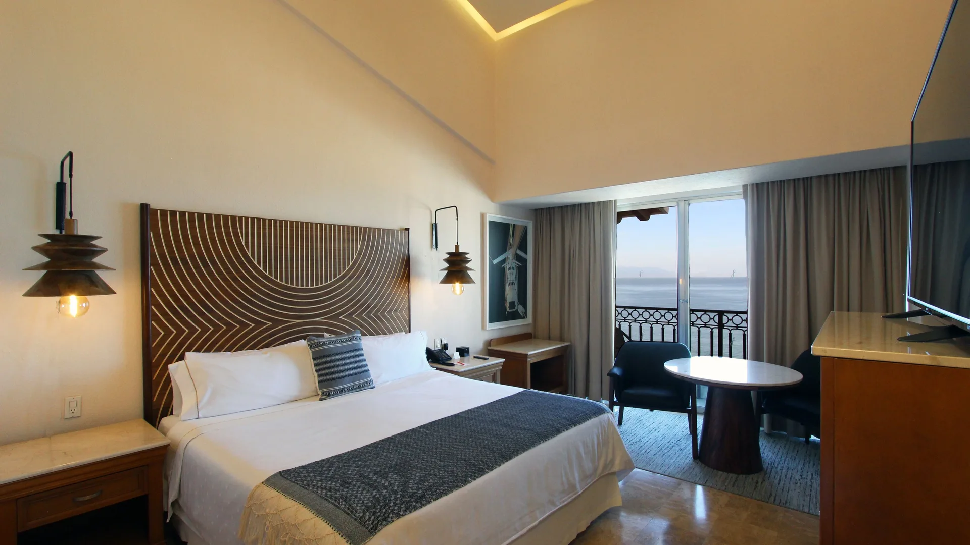 Honeymoon Suite king bed and balcony ocean view at Fiesta Americana Puerto Vallarta & Spa.