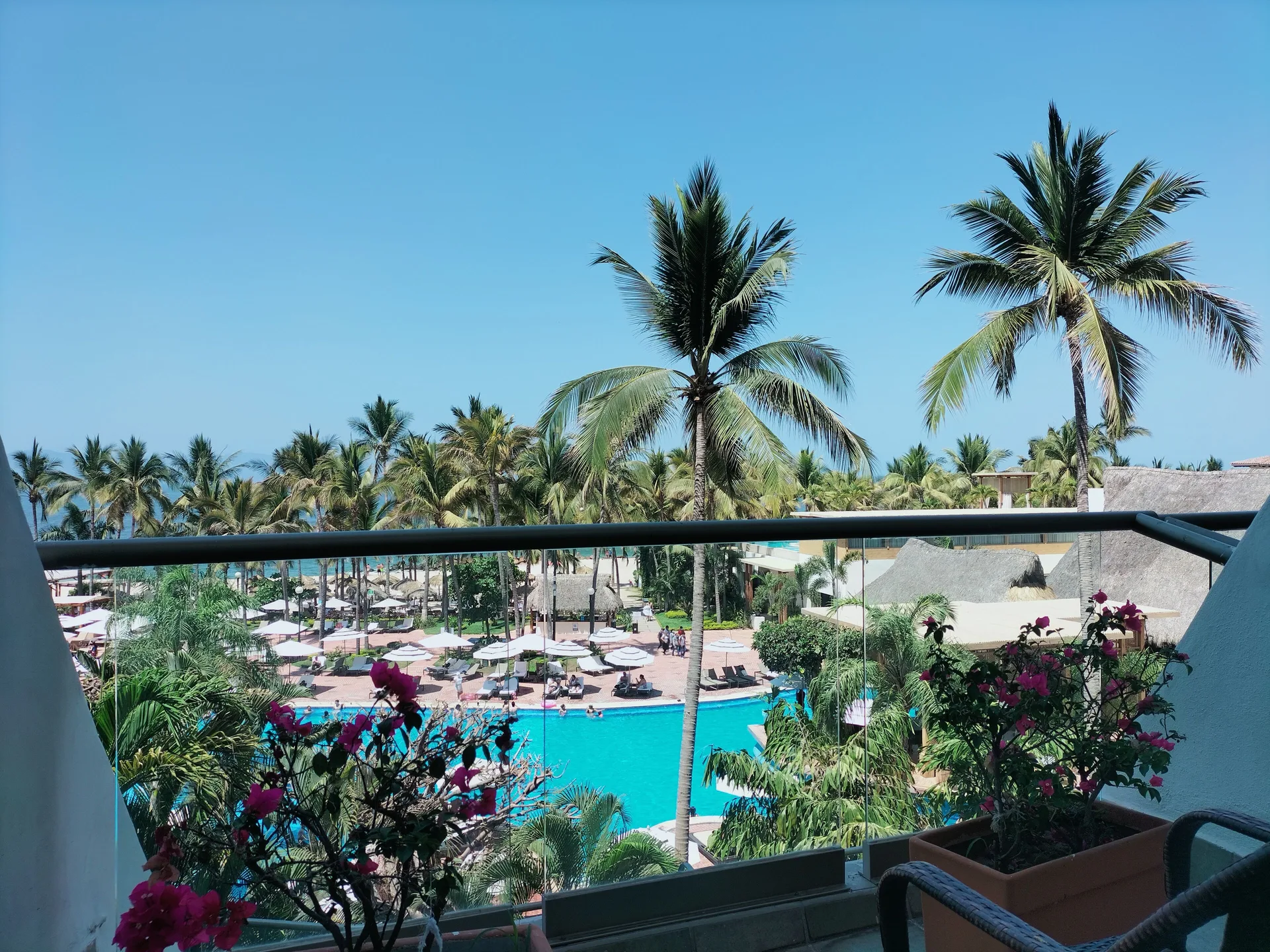 Partial ocean view from a Superior Room balcony at Fiesta Americana Puerto Vallarta & Spa over pool and palms.