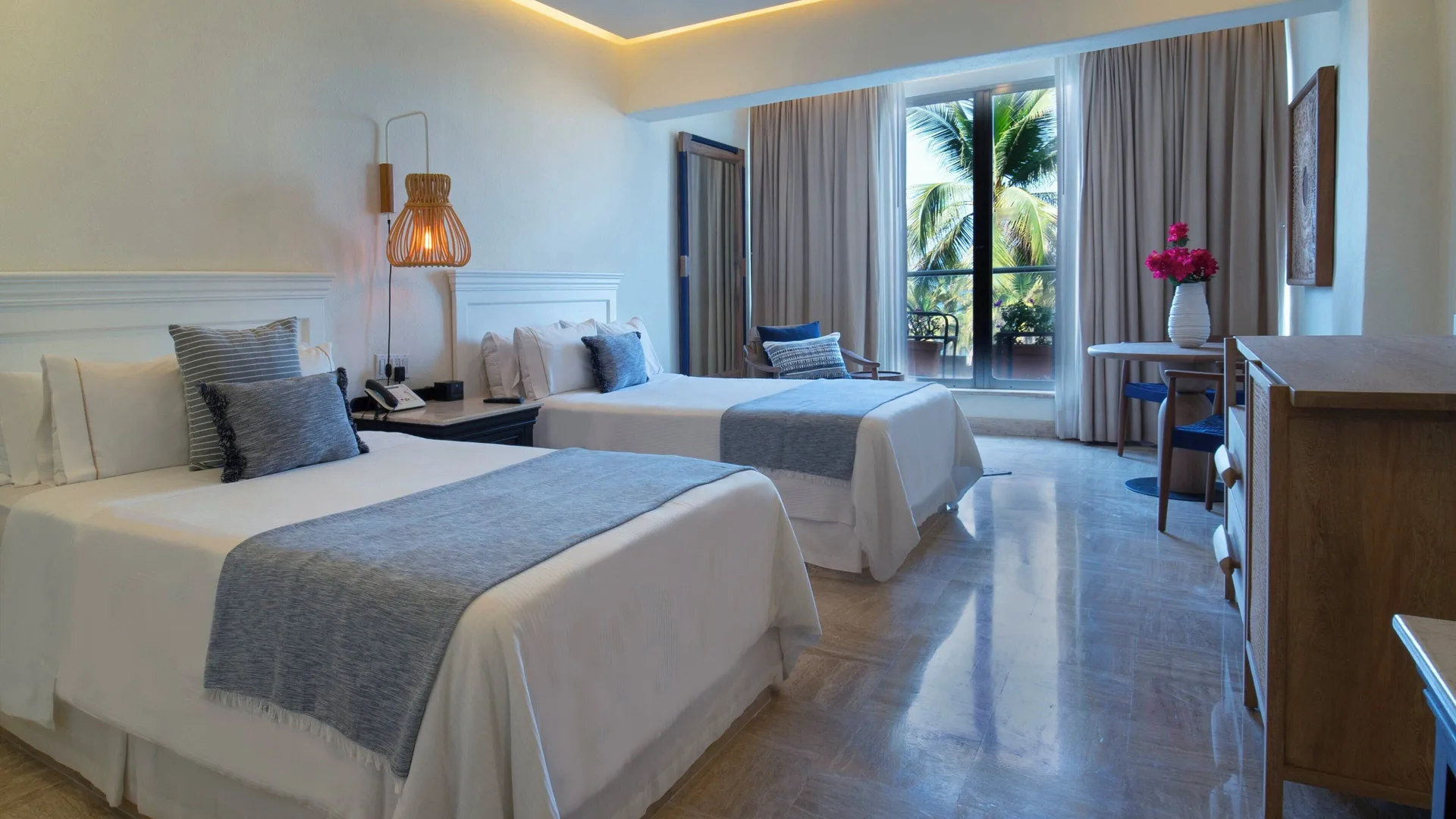 Superior Room two beds at Fiesta Americana Puerto Vallarta & Spa with palm view through balcony doors.