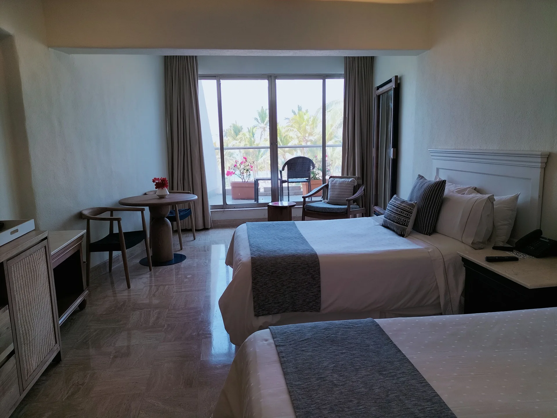 Superior Room two beds at Fiesta Americana Puerto Vallarta & Spa with balcony seating and palm views.
