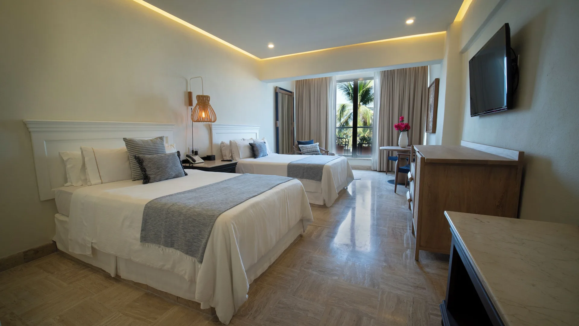 Superior Room two beds at Fiesta Americana Puerto Vallarta & Spa with wall TV and balcony beyond.