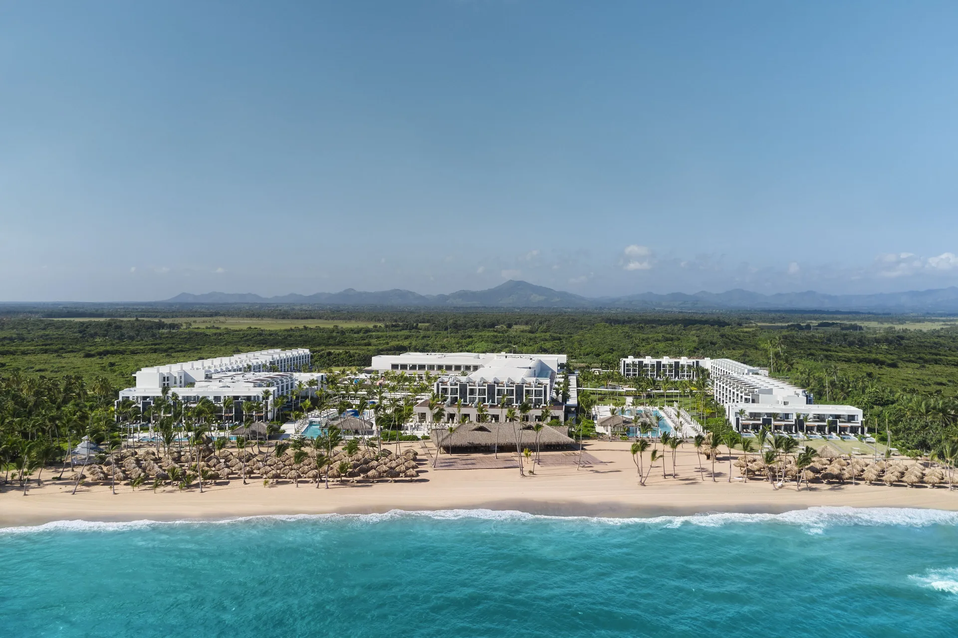 Aerial view of the beachfront resort and turquoise water at Finest Punta Cana.