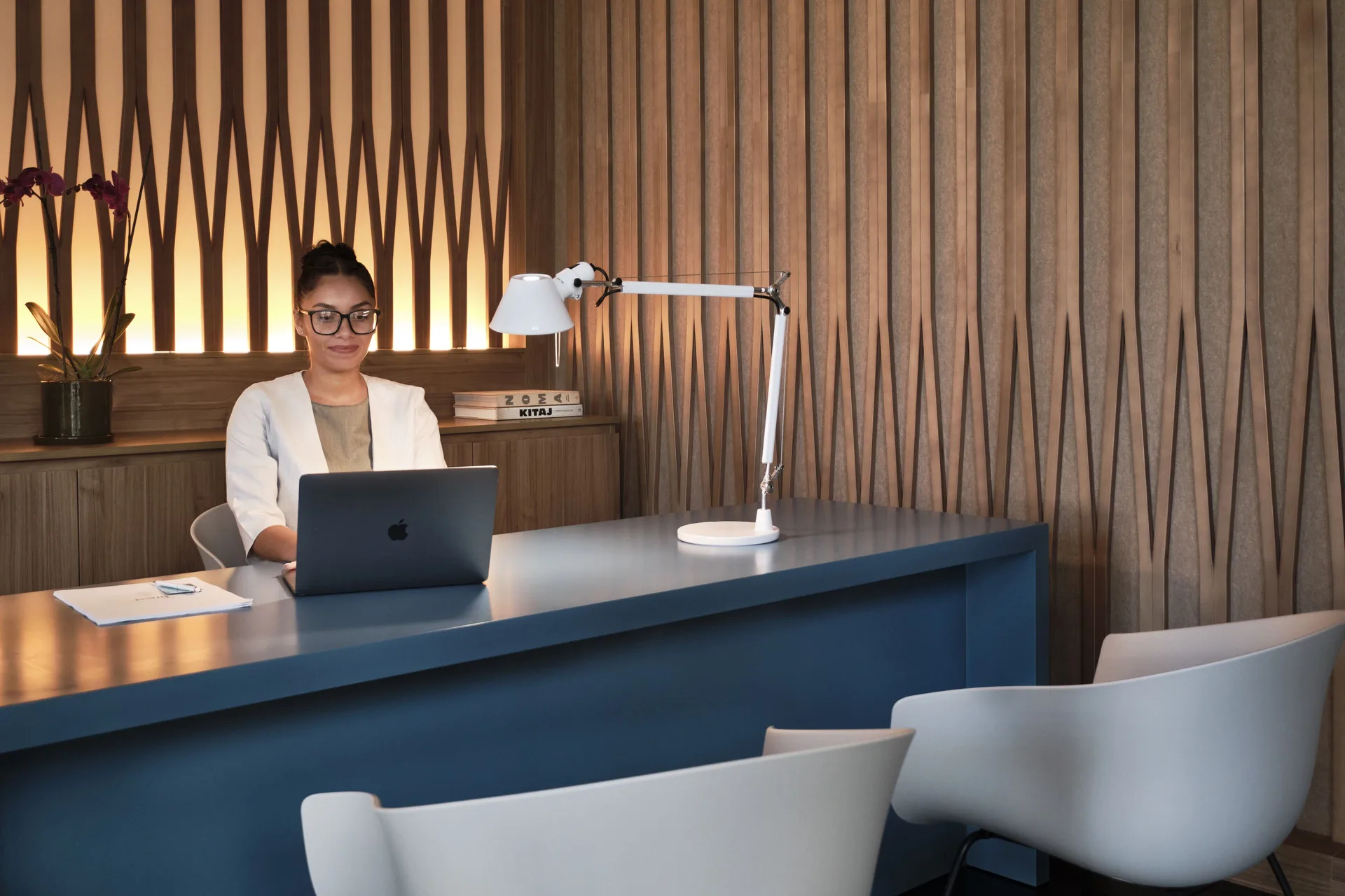 Concierge desk with seating and wood slat walls at Finest Punta Cana.