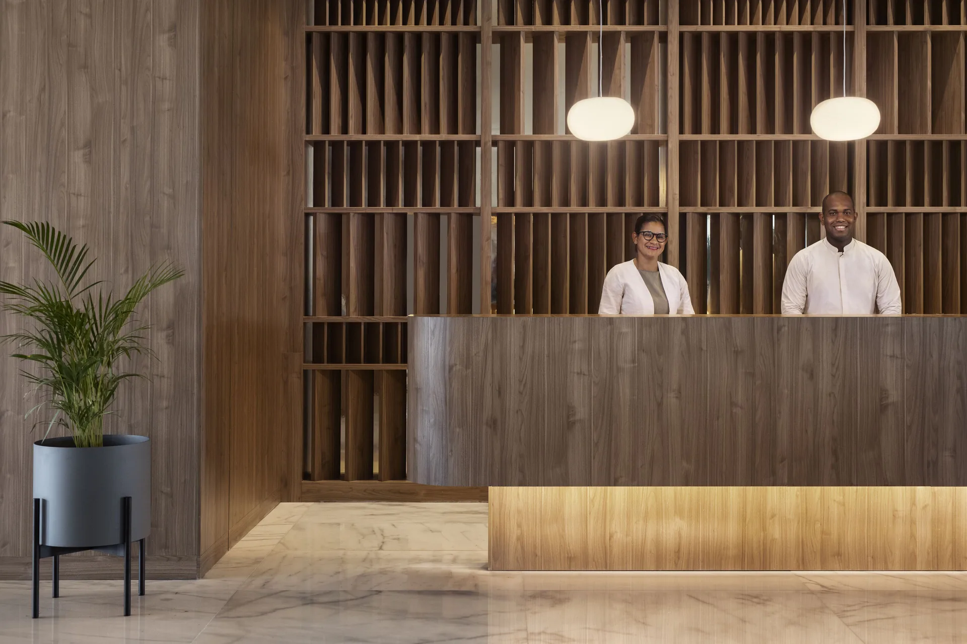 Reception desk with two staff members in the lobby at Finest Punta Cana.