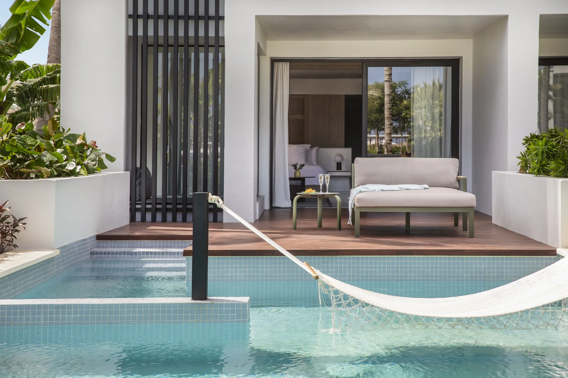 Swim-up suite terrace with plunge pool and hammock at Finest Punta Cana.