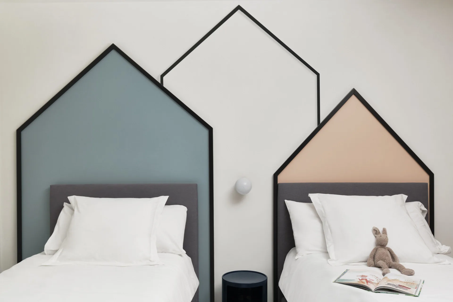 Two children's beds in the Family Suite at Finest Punta Cana with playful house-shaped wall accents.