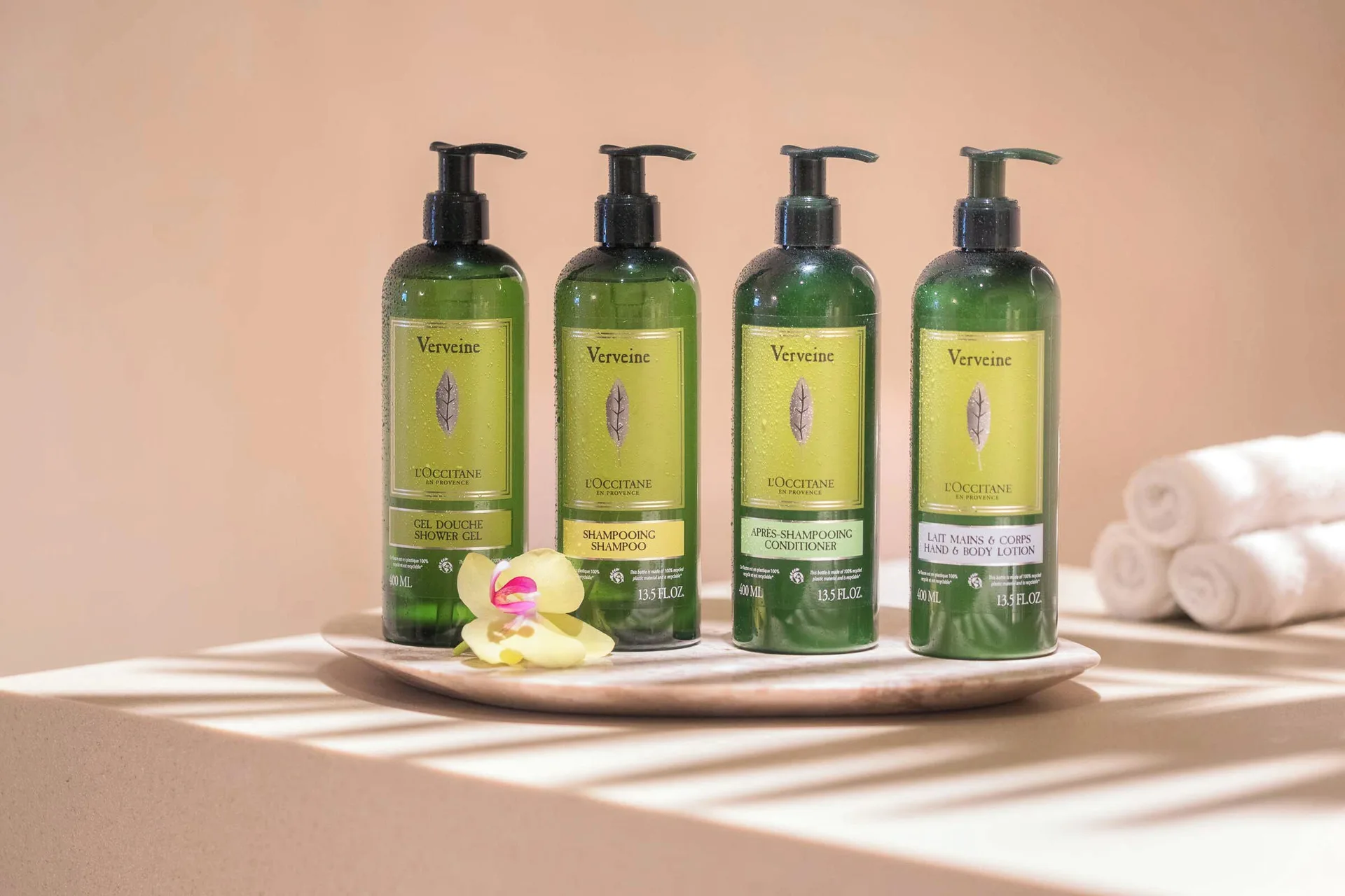Bath amenity bottles on a tray with towels in a junior suite at Finest Punta Cana.