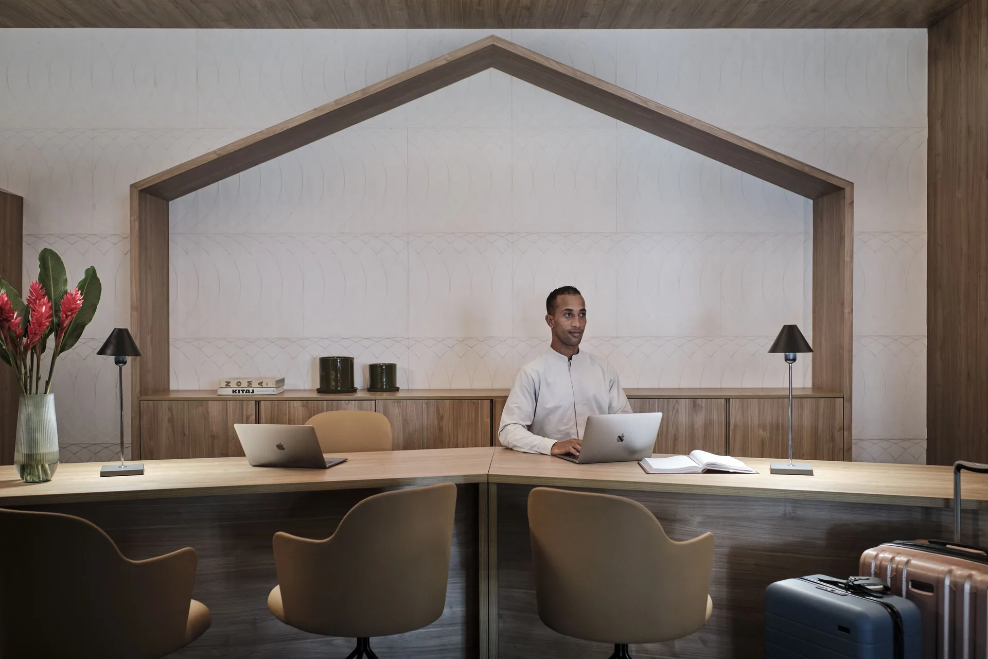 Reception desk with staff, laptops, chairs, and luggage at Finest Punta Cana.