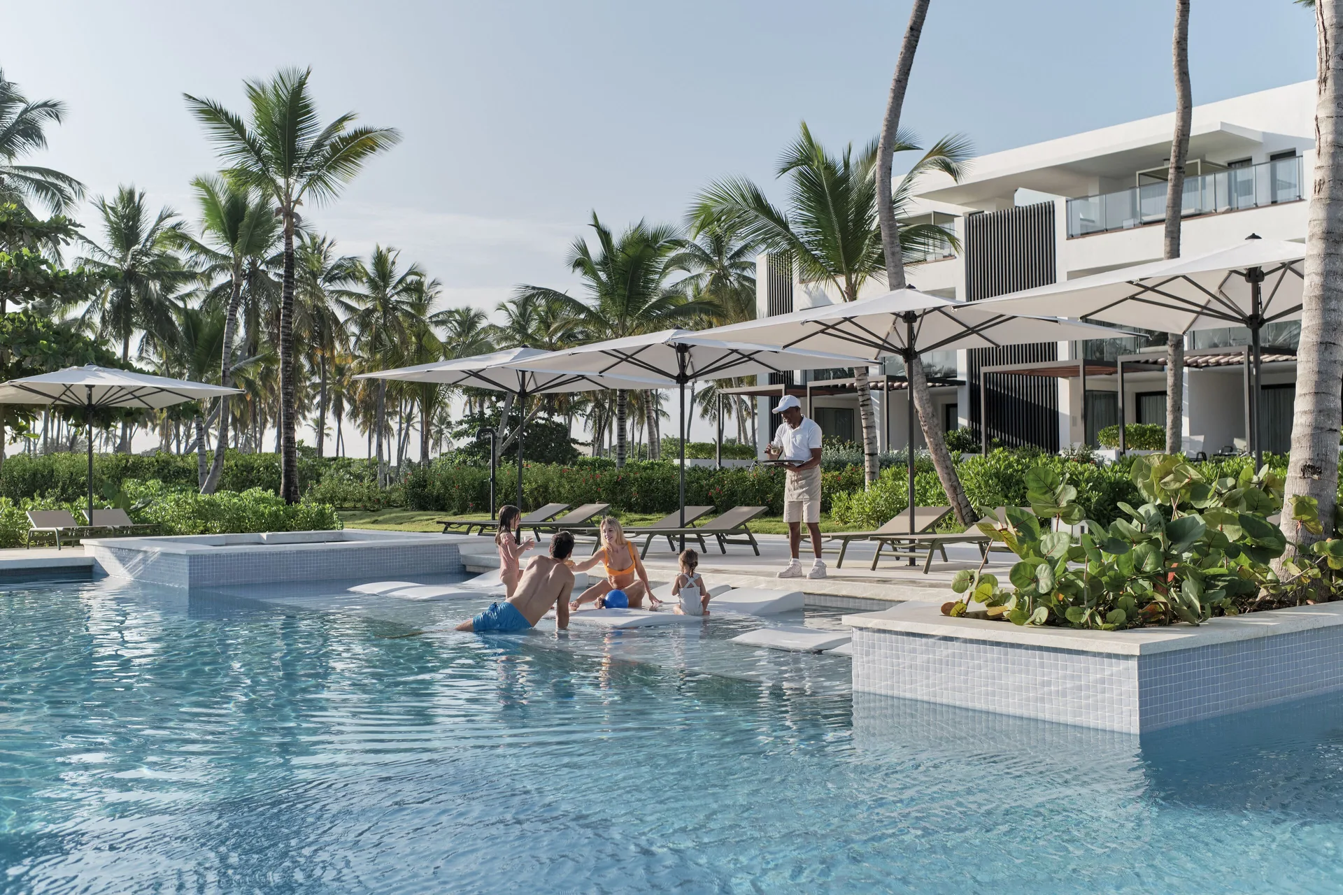 Family by the shared pool near Finest Punta Cana at Finest Punta Cana.