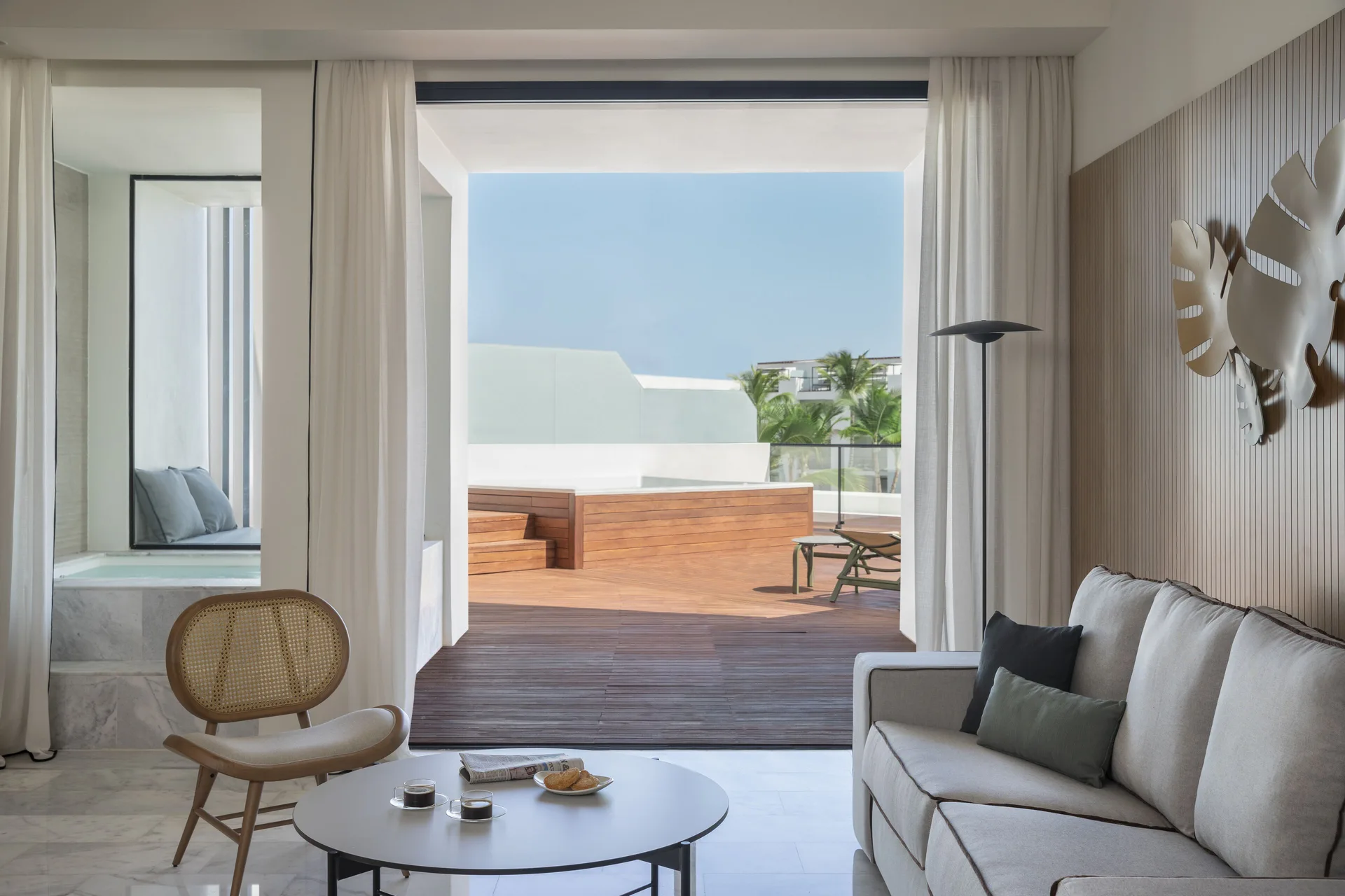Living area in a rooftop terrace suite with sliding doors at Finest Punta Cana.