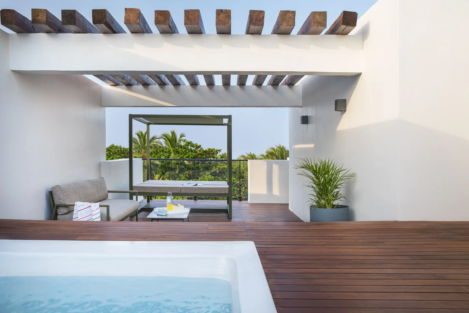 Rooftop terrace plunge pool with daybed and seating at Finest Punta Cana.