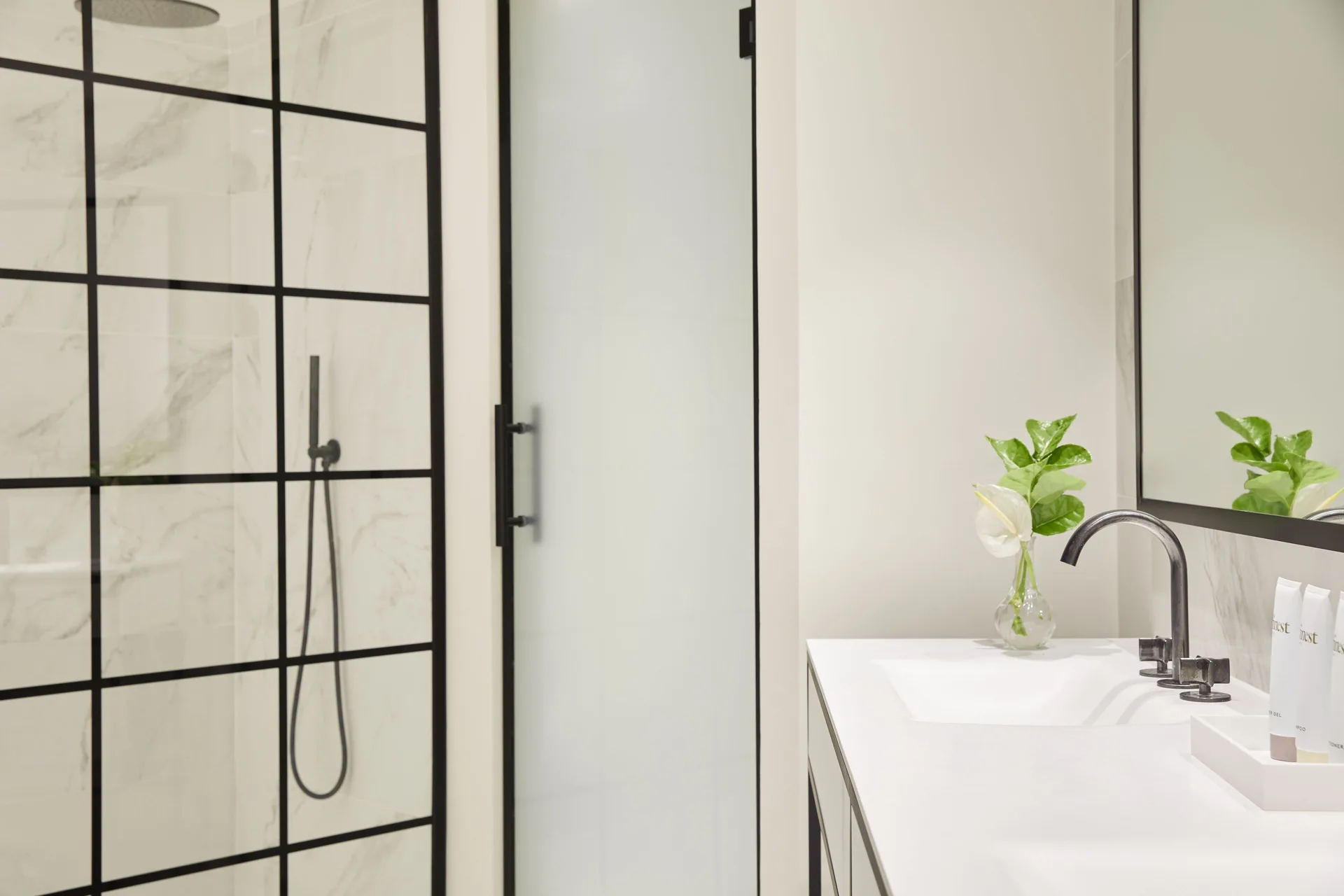 Junior Suite bathroom with shower, vanity, and mirror at Finest Punta Cana.