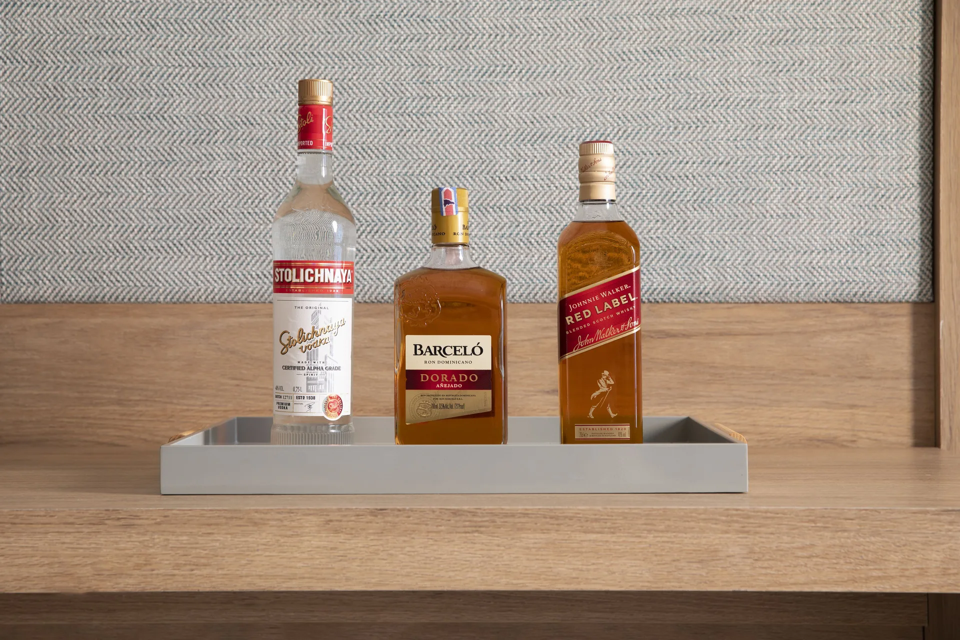 Three liquor bottles on an in-room tray in a Junior Suite at Finest Punta Cana.