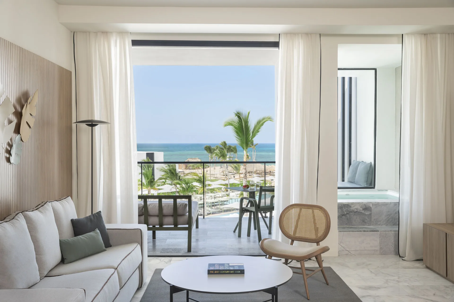 Junior Suite Ocean View living area and balcony at Finest Punta Cana with ocean beyond.