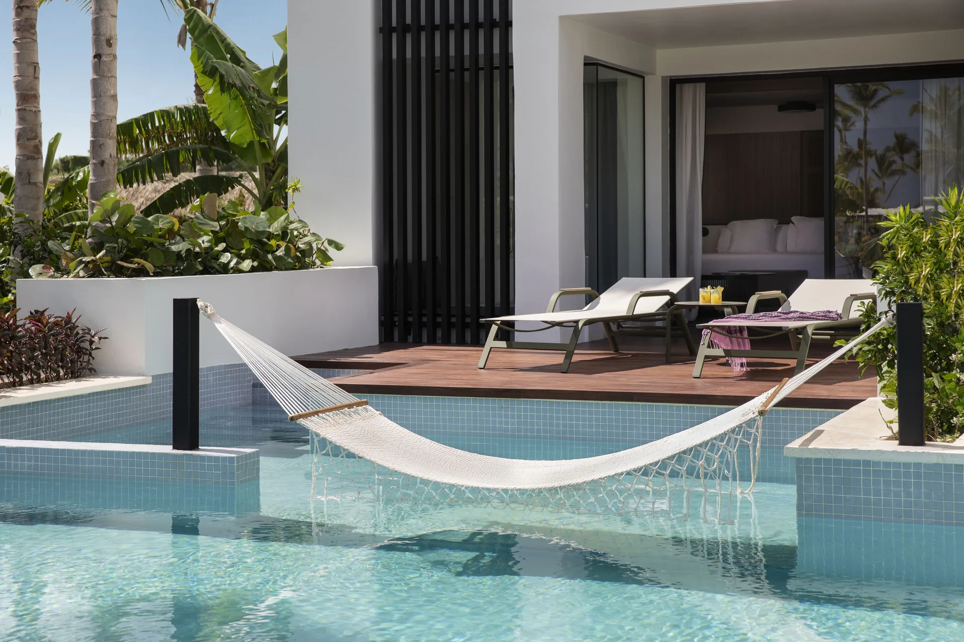 Junior Swim-Up Suite patio with hammock and pool at Finest Punta Cana.