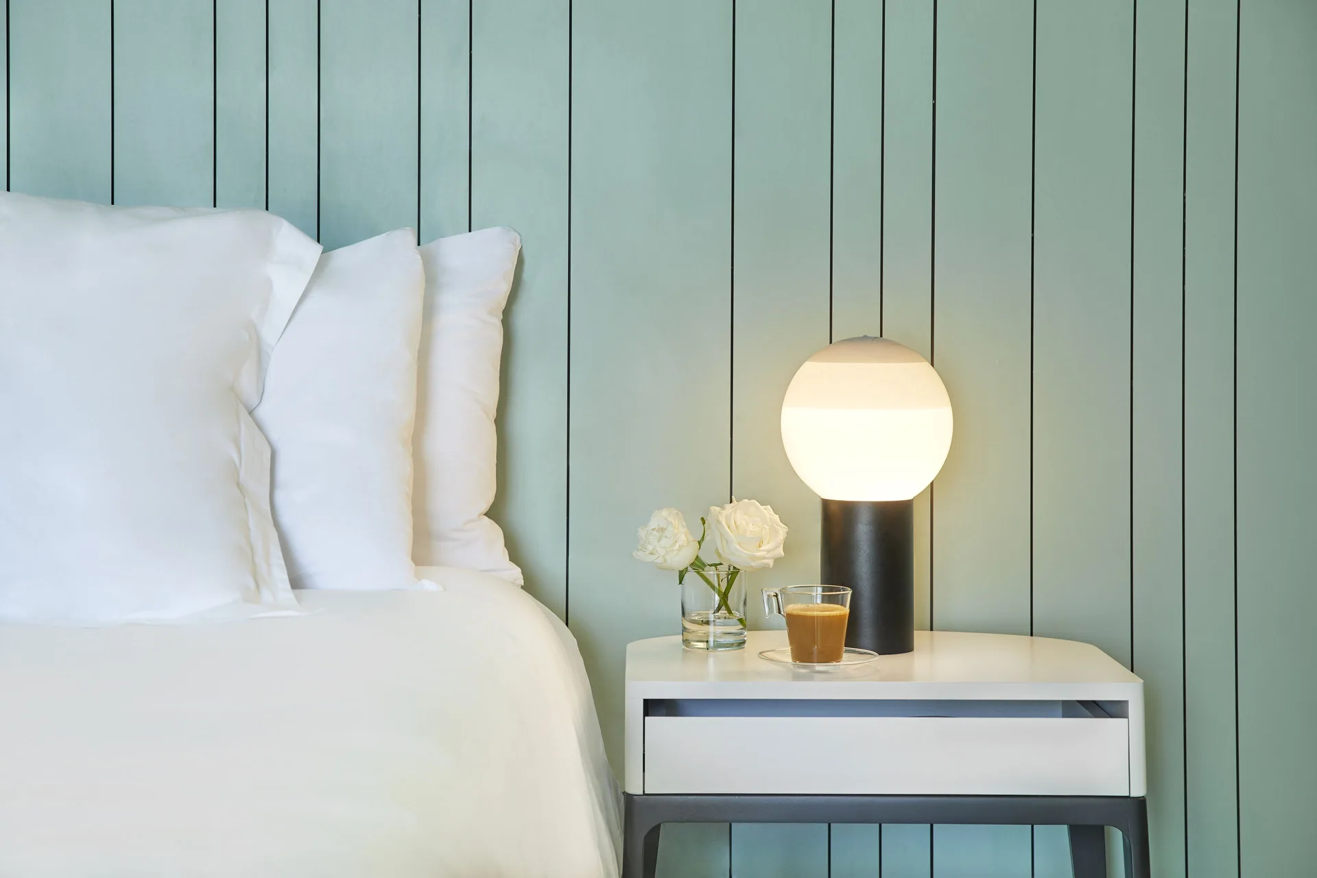 Bedside table and white bedding in a Terrace Suite with Plunge Pool at Finest Punta Cana.