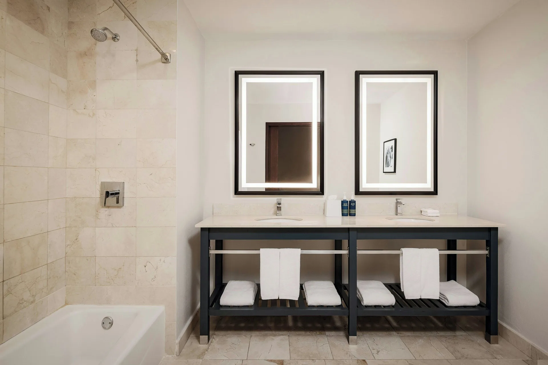 One-bedroom suite bathroom with double vanity and bathtub at Four Points Puntacana Village.