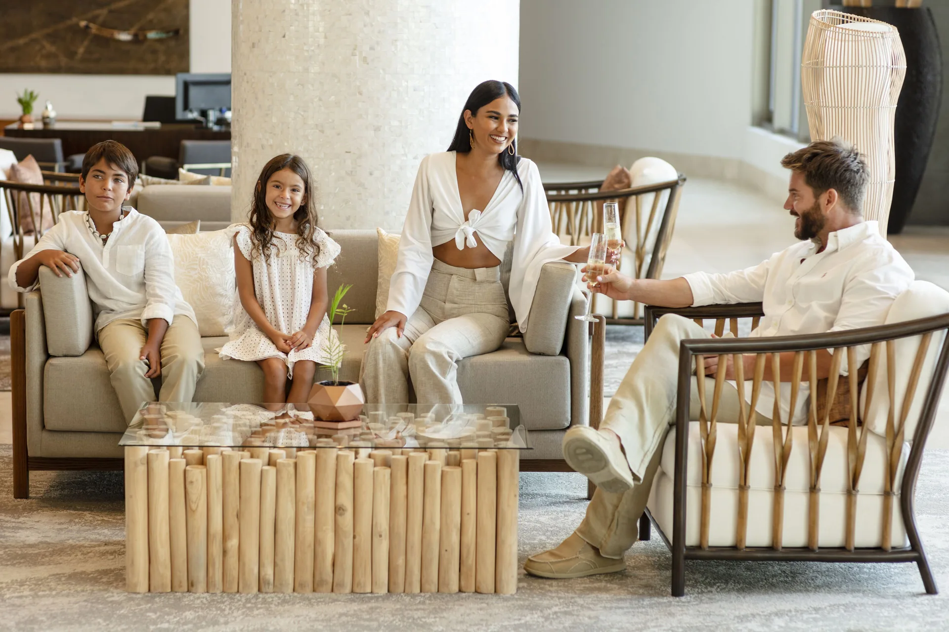 Family seated in the lobby lounge at Garza Blanca Los Cabos.