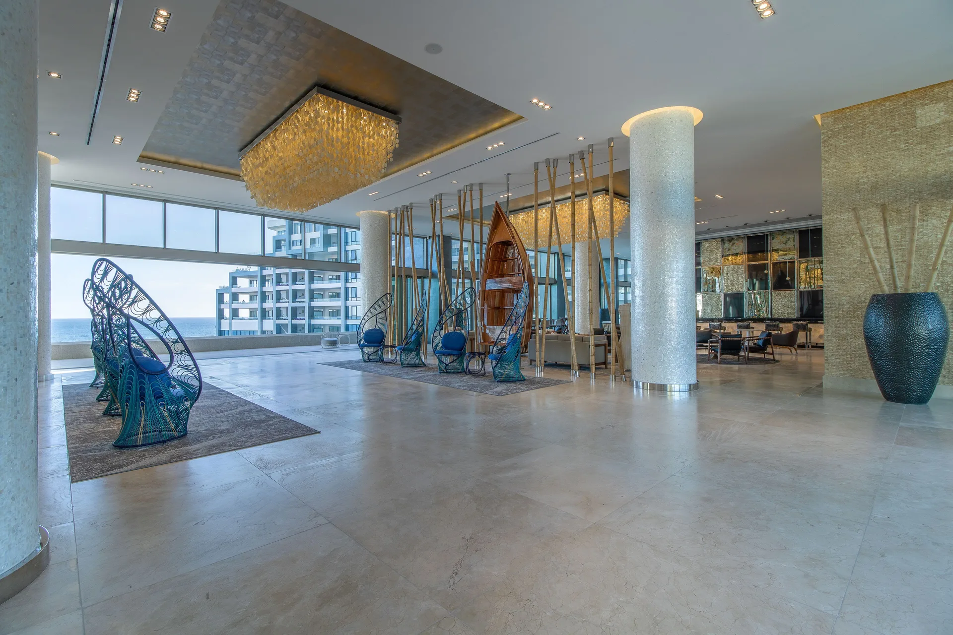 Open lobby lounge with ocean-facing windows at Garza Blanca Los Cabos.