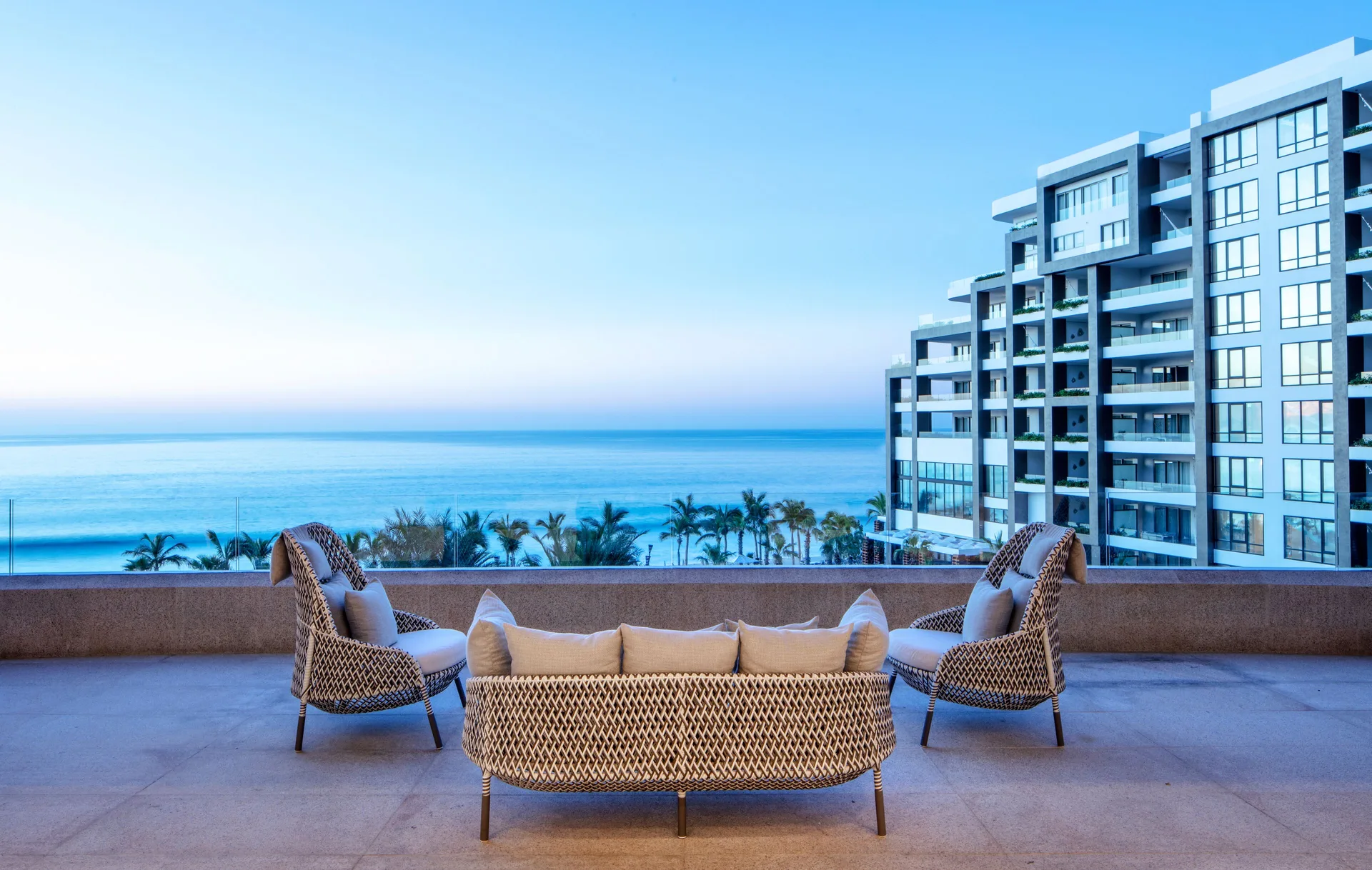 Outdoor terrace seating overlooking the ocean at Garza Blanca Los Cabos.