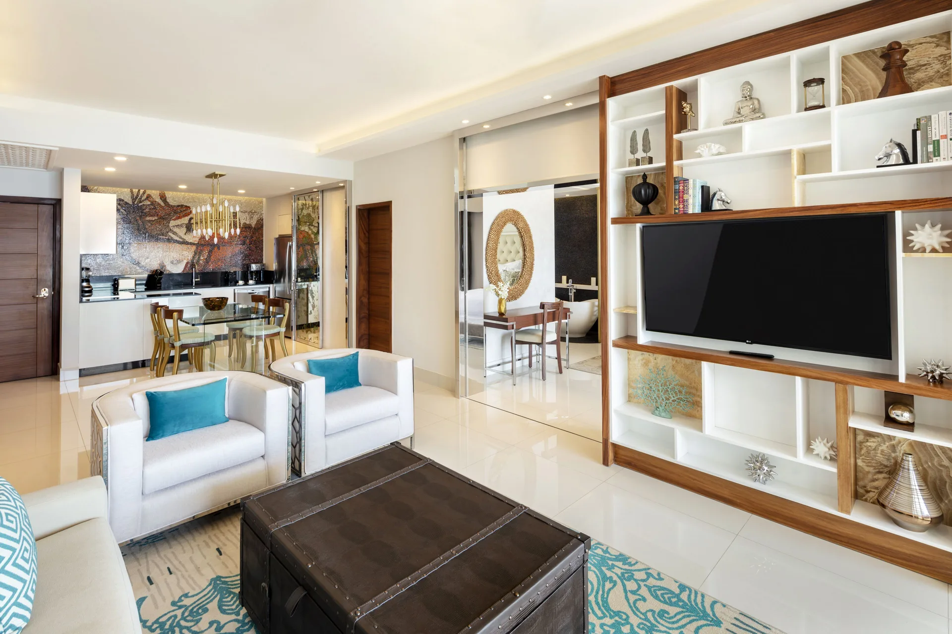 1 Bedroom Suite lounge with TV shelving, dining area, and bedroom doorway at Garza Blanca Los Cabos.