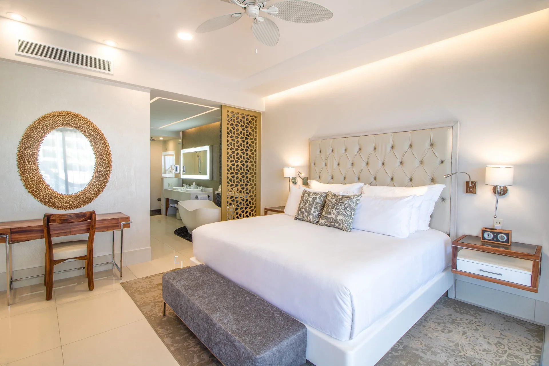 One Bedroom Suite king bed and open bathroom at Garza Blanca Los Cabos.