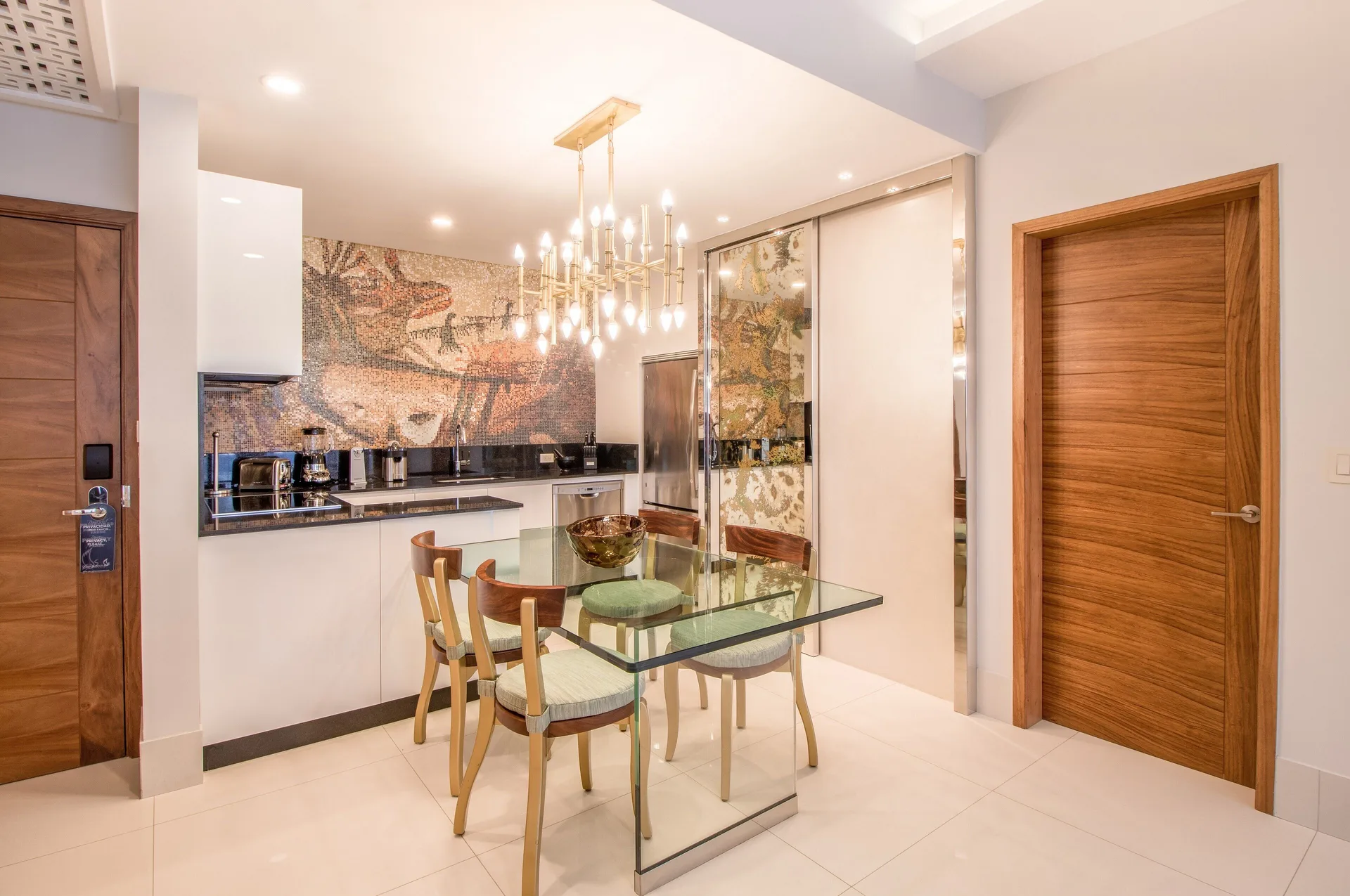 One Bedroom Suite kitchen and glass dining table at Garza Blanca Los Cabos.